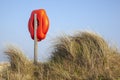 Lifesaving ring amongst the grasses, Walberswick beach, Suffolk, England Royalty Free Stock Photo