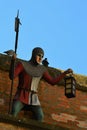 Lifesize figurine of medieval ciy guard with halberd and lantern, standing on medieval walls of Trnava city, western Slovakia Royalty Free Stock Photo