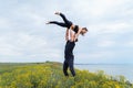 Lifestyle acroyoga and yoga poses. Pair of sportsman and sportswoman standing in the position of asana. Acrobat holding girl