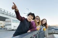 Lifestyle of adolescents, boy and two teen girls are walking in the city. Laughing, talking children eating street food, having Royalty Free Stock Photo