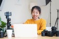 Lifestyle Asia young women photographer and freelance holding a dslr camera in home office.