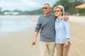 Lifestyle asian senior couple happy walking and relax on the beach. Tourism elderly family travel leisure and activity after reti