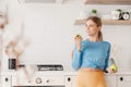 lifestyle, Beautiful Caucasian sporty woman happy smiling holding green apple in kitchen. Healthy snack for fitness girl Royalty Free Stock Photo