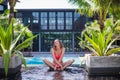 Lifestyle bright summer portrait of beautiful woman with nice body, relaxed at the pool on her vacation. Royalty Free Stock Photo