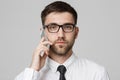 Lifestyle and Business Concept - Portrait of a handsome businessman serious talking with mobile phone. Isolated White background. Royalty Free Stock Photo