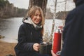 Lifestyle capture of happy couple drinking hot tea outdoor on cozy warm walk Royalty Free Stock Photo