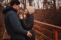 Lifestyle capture of happy couple drinking hot tea outdoor on cozy warm walk Royalty Free Stock Photo