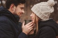 Lifestyle capture of happy couple drinking hot tea outdoor on cozy warm walk in forest Royalty Free Stock Photo