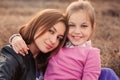 Lifestyle capture of happy mother and preteen daughter having fun outdoor. Loving family spending time together on the walk. Royalty Free Stock Photo