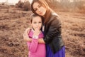 Lifestyle capture of happy mother and preteen daughter having fun outdoor. Loving family spending time together on the walk. Royalty Free Stock Photo