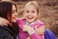 Lifestyle capture of happy mother and preteen daughter having fun outdoor. Loving family spending time together on the walk. Royalty Free Stock Photo