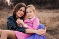 Lifestyle capture of happy mother and preteen daughter having fun outdoor. Loving family spending time together on the walk. Royalty Free Stock Photo