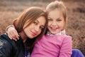 Lifestyle capture of happy mother and preteen daughter having fun outdoor. Loving family spending time together on the walk. Royalty Free Stock Photo