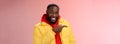 Charismatic carefree handsome black bearded guy in yellow jacket laughing friendly look camera chat pointing left show Royalty Free Stock Photo