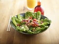 Lifestyle Chilli Chicken Salad with cabbage, lettuce, onion, green beans, cashew and sauce in big bowl on wooden table Royalty Free Stock Photo