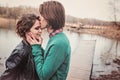 Lifestyle close up outdoor portrait of young loving couple kissing