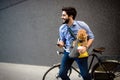 Lifestyle, transport, communication and people concept . Young man with bicycle and smartphone on city street