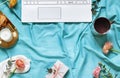 Lifestyle concept flat lay on the blue bed blanket with a keyboard. Royalty Free Stock Photo