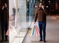 Black man talking on mobile phone holding shopping bag Royalty Free Stock Photo