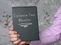 Lifestyle concept about Optimize Your Monitor with inscription on the piece of paper