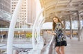 Lifestyle concept,Portrait beautiful woman using cellphone and walking in the city,Female confidence happy and smiling Royalty Free Stock Photo