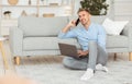 Portrait of successful smiling man using pc talking on phone Royalty Free Stock Photo