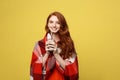 Lifestyle Concept: Portrait of woman basking with plaid and enjoy drinking chocolate Isolated over vivid yellow Royalty Free Stock Photo