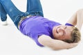 Lifestyle concept: Young Smiling Happy Caucasian Handsome Man Lying on Floor and Laughing. Casual Clothes Style. Royalty Free Stock Photo