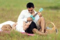 Lifestyle couple happy honeymoon in sunny time. Asian young couple sitting picnic and relax