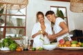 Lifestyle. Couple At Kitchen Cooking Healthy Vegetarian Food And Having Fun. Beautiful Woman Peeling Apple. Royalty Free Stock Photo