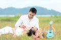 Lifestyle couple picnic and relax. People young woman and man having fun and happy picnic in the meadow and field sunny time in ho Royalty Free Stock Photo