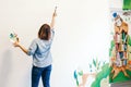 Lifestyle creative hobby and freelance artistic work side job concept. Caucasian woman artist hand painting murals on walls Royalty Free Stock Photo