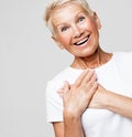 older woman presses her hands to her chest and feels happy, good news Royalty Free Stock Photo