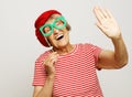 Lifestyle, emotion and people concept: funny grandmother with fake glasses, laughs and ready for party