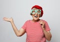 Lifestyle, emotion and people concept: funny grandmother with fake glasses, laughs and ready for party