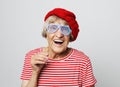 Lifestyle, emotion and people concept: funny grandmother with fake glasses, laughs and ready for party