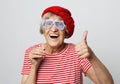 Lifestyle, emotion and people concept: funny grandmother with fake glasses, laughs and ready for party