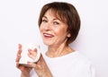 Old excited lady smiling laughing, holding cup drinking coffee, tea, beverage on white background Royalty Free Stock Photo