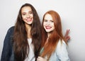 lifestyle, emotion and people concept: Two young girl friends standing together and having fun. Royalty Free Stock Photo