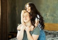 Lifestyle, family and young people concept: lovely couple in love hugging and kissing, sitting on bed Royalty Free Stock Photo