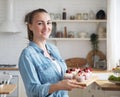 Lifestyle, food, people and small business concept: Young baker woman holding cupcakes. Royalty Free Stock Photo