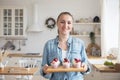 Lifestyle, food, people and small business concept: Young baker woman holding cupcakes. Royalty Free Stock Photo