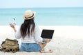 Lifestyle freelance woman listen music after using laptop working and relax on the beach