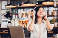 Lifestyle freelance woman he using earphones listening music during working on laptop computer Royalty Free Stock Photo