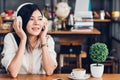 Lifestyle freelance woman he using earphones listening music during working on laptop computer Royalty Free Stock Photo