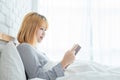 Lifestyle happy young Asian woman enjoying lying on the bed reading book pleasure in casual clothing at home. Royalty Free Stock Photo