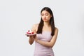 Lifestyle, holidays, celebration and food concept. Reluctant and upset, gloomy asian woman in dress, refusing eat cake