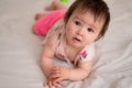 lifestyle home portrait of sweet and adorable mixed ethnicity Asian Caucasian baby girl playing with color blocks on bed excited Royalty Free Stock Photo