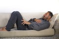 Lifestyle home portrait of young attractive and happy white man with beard and casual shirt lying relaxed and cozy at living room