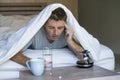 Lifestyle home portrait of young exhausted and wasted man waking up suffering headache and hangover after drinking alcohol at nigh Royalty Free Stock Photo